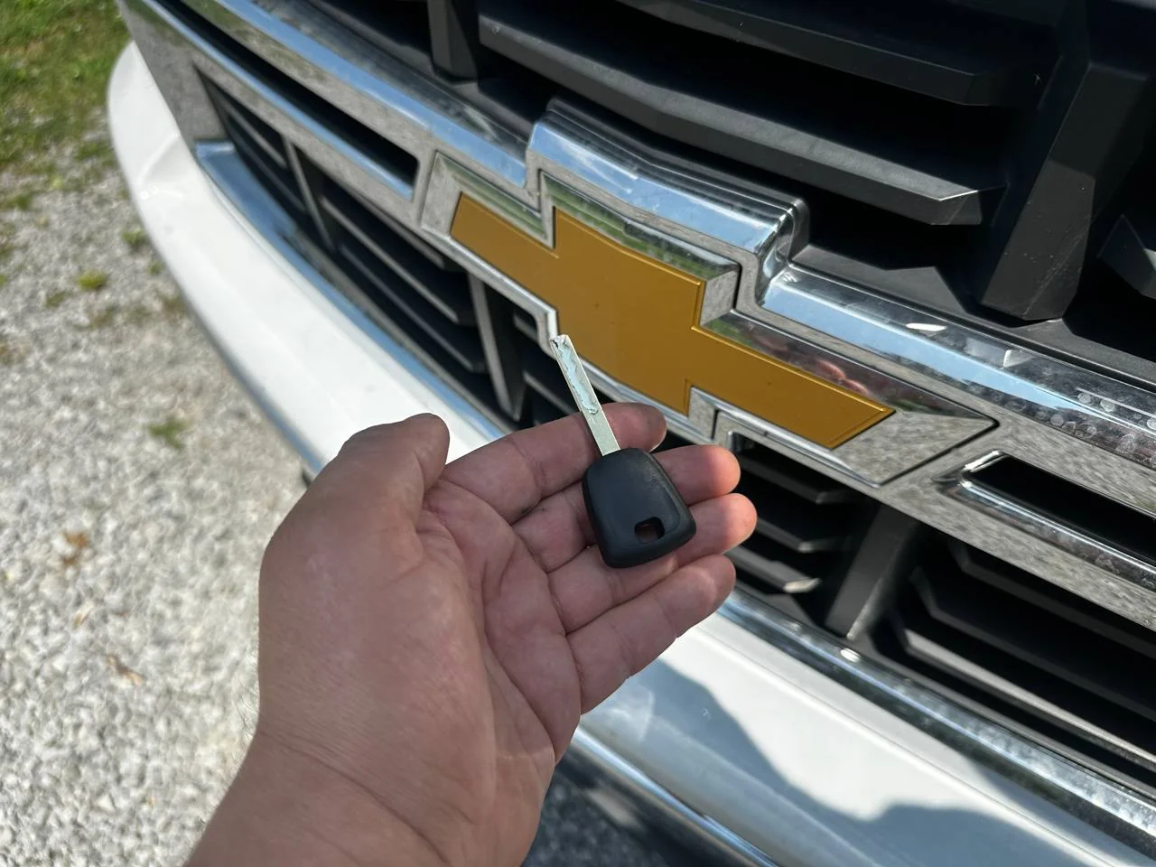 Locksmith unlocking a locked Chevy truck door using professional tools without damage at night in Bowling Green Kentucky