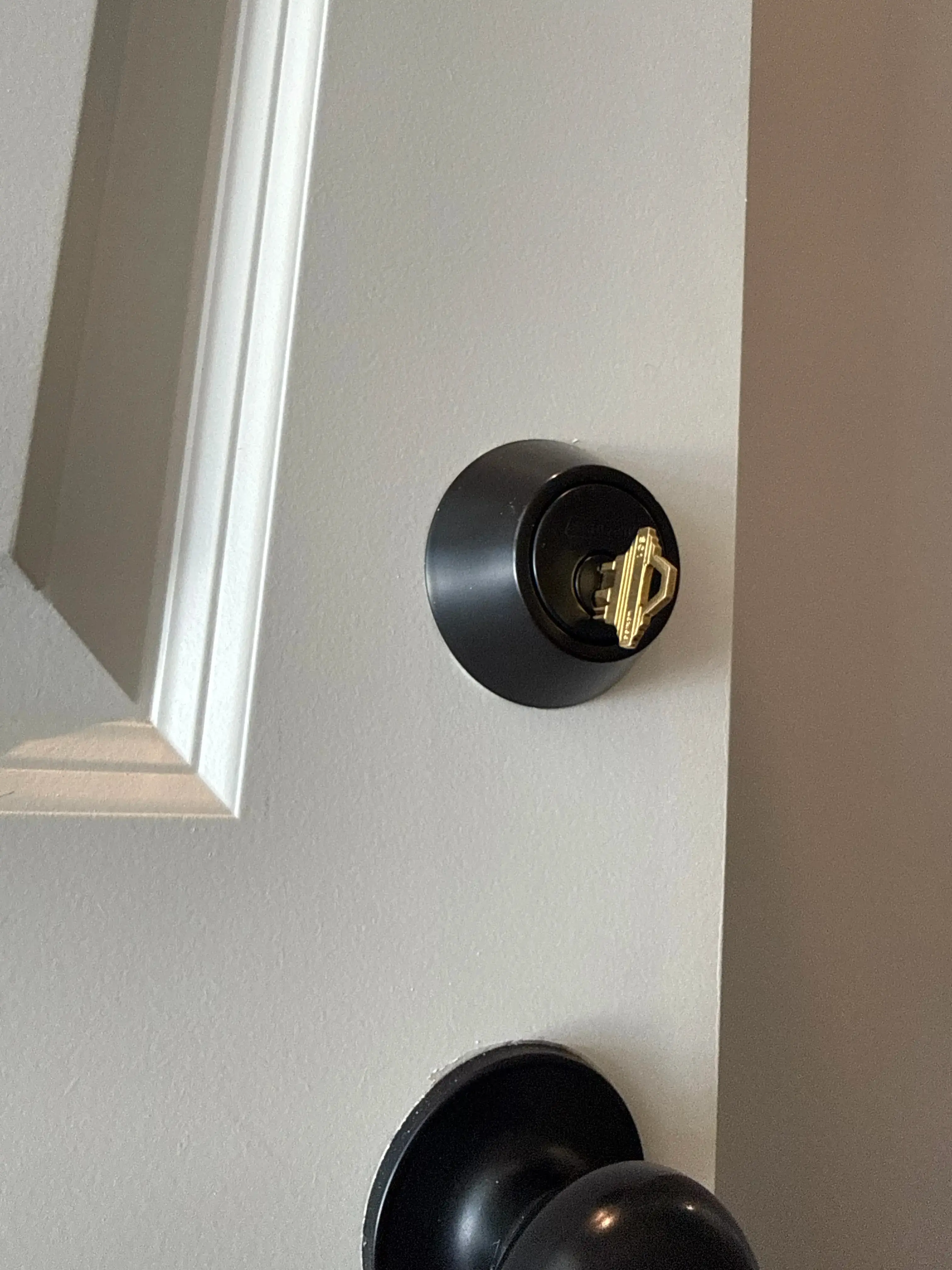 Locksmith rekeying residential door locks and testing door knob after moving into a new home in Bowling Green Kentucky